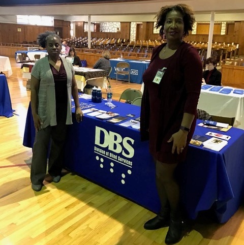 La’Verne Scott and Bertha Hyche standing next to the DBS exhibit table